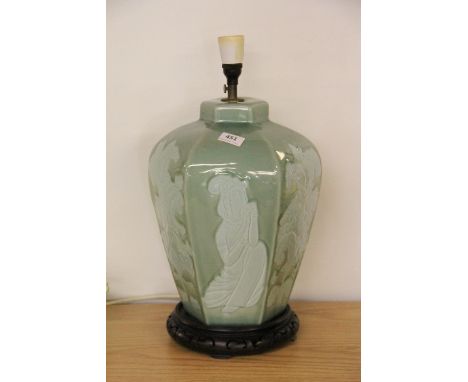 An oriental style porcelain table lamp on a carved wooden base, H 46cm