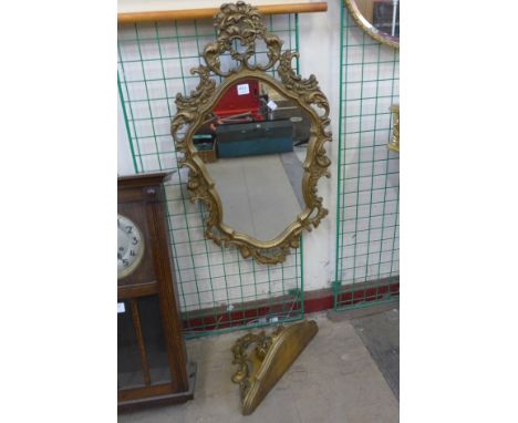 A gilt framed mirror and wall bracket