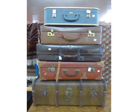 An early 20th Century steamer trunk and four vintage suitcases