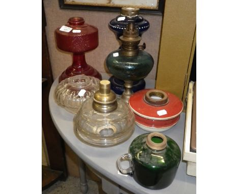 A Victorian blue glass oil lamp and a collection of similar oil lamps