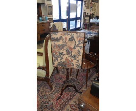 A 19th century mahogany tripod firescreen