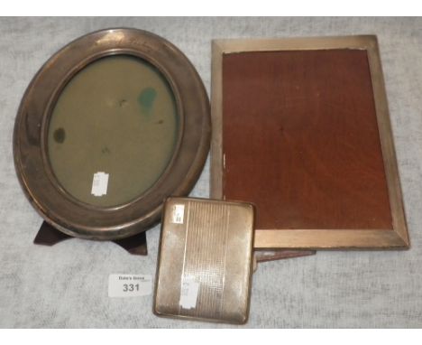 A large oval silver frame with engraving 'Man of Destiny' and an engine-turned rectangular silver photograph frame and an eng