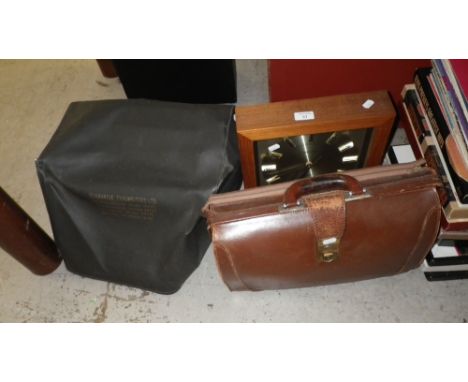 A Toshiba wall clock, a vintage leather briefcase and a vintage Imperial typewriter with cover