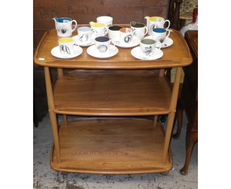 An Ercol light elm three-tier trolley