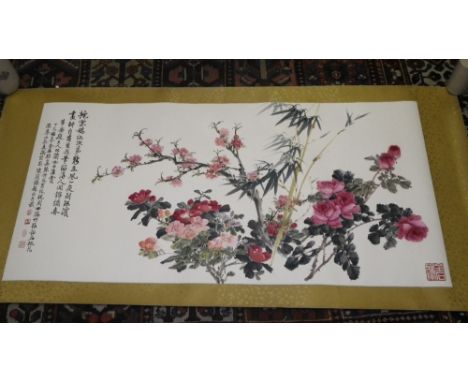A large Chinese scroll painting of blossom and rose bushes with text to the end and seal mark