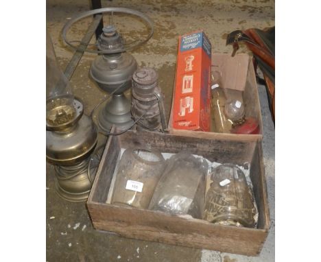 An Aladdin oil lamp and a collection of oil lamps and shades