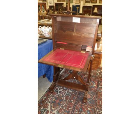 An Edwardian walnut firescreen/students desk, with makers label, 'Arthur Lane, Architectural Carver and Joiner, Mintern near 