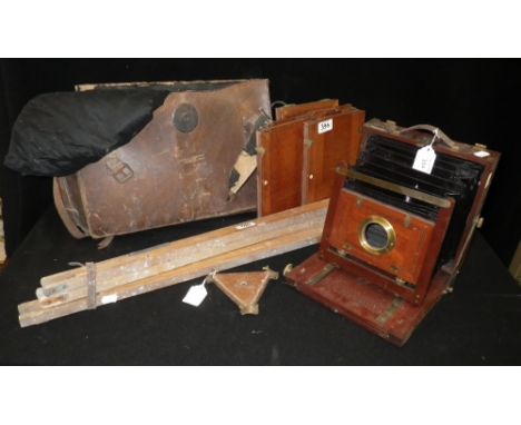 A 19th century folding mahogany and brass plate camera (no lens) with three mahogany plate holders and an associated tripod s
