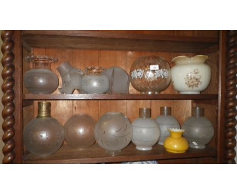 A collection of frosted oil lamp shades and similar light fittings