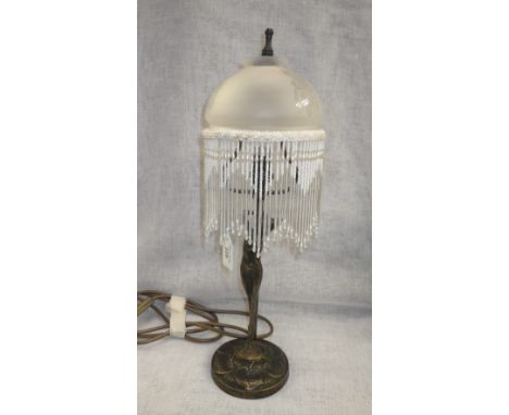 An Art Nouveau style lamp with tasseled glass shade