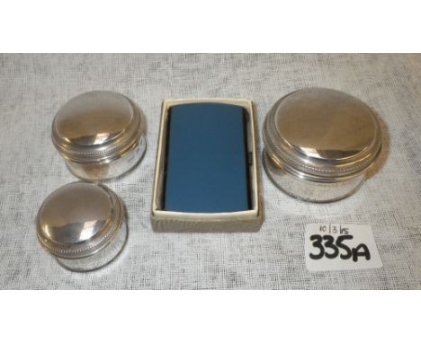 A set of three graduated modern circular silver trinket boxes and a boxed enamelled silver and silver gilt cigarette case