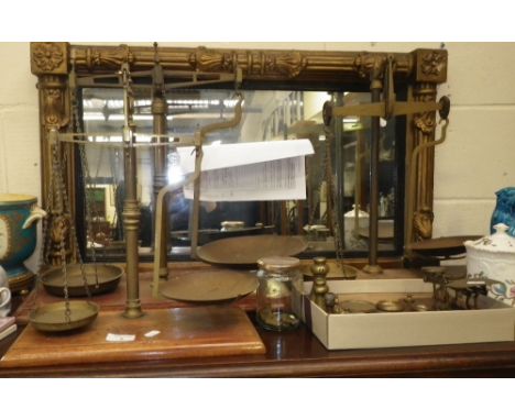 A pair of 19th century brass scales on a mahogany base, two others similar, a set of postal scales and a quantity of various 