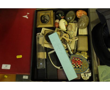 A tray containing two whistles, a pair of stirrups, a British Automobile Racing Club cloth badge, marble eggs etc.
