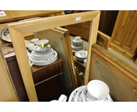 A light oak framed wall mirror