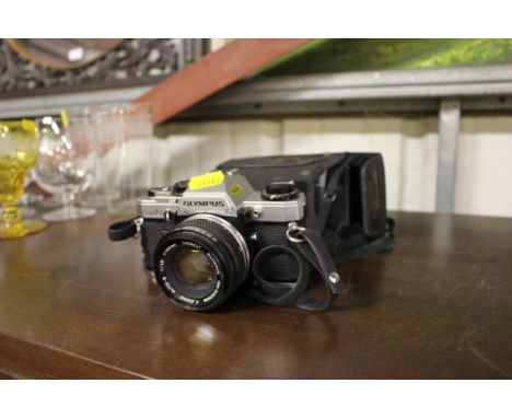 An Olympus camera; and a Kodak camera 