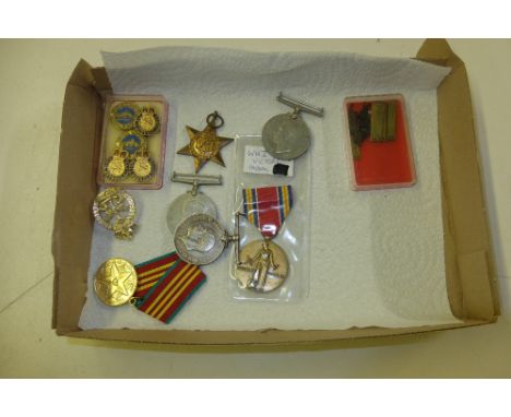 A tray of various medals to include 1939-45 Star, two other WW2 medals, various badges etc. 