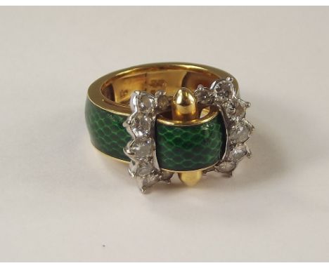 KUTCHINSKY. An 18ct. gold Kutchinsky buckle ring, the shank part enamelled in green simulated snakeskin, the buckle set with 