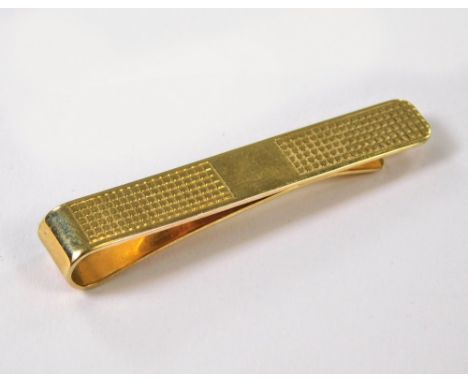 TIE CLIP. A 9ct. gold engine turned tie clip. Approx. 6.8g.