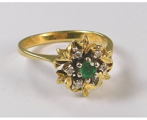 DRESS RING. An 18ct. gold emerald &amp; diamond cluster ring. Size L. Approx. 3.4g.