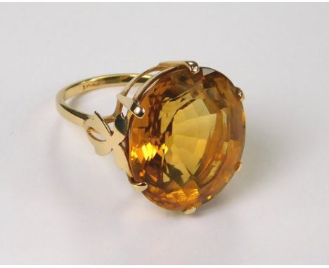 GOLD RING. A 9ct. gold dress ring, set a large faceted citrine. Size Q.