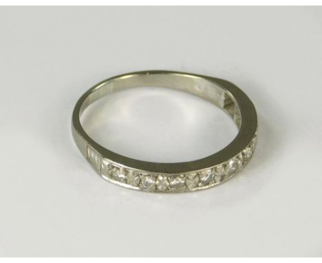 ETERNITY RING. A half hoop, diamond set eternity ring in white metal. Size R/S.