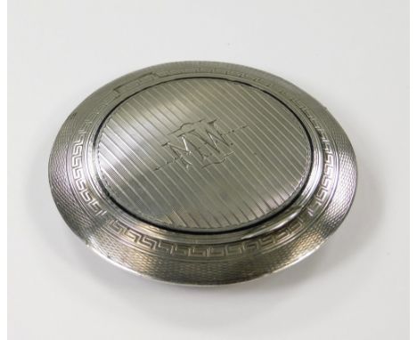 POWDER COMPACT. An Art Deco engine turned &amp; black enamelled silver, discus shaped powder compact. Import marks for London