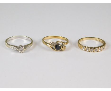 GOLD RINGS. A 9ct. gold sapphire &amp; illusion set diamond cross-over ring, a 9ct. white gold diamond set ring &amp; one oth