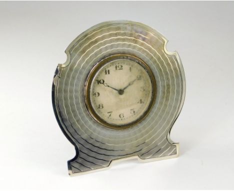 SILVER CLOCK. An engine turned silver dressing table clock. Birmingham 1931. Height 10cm.