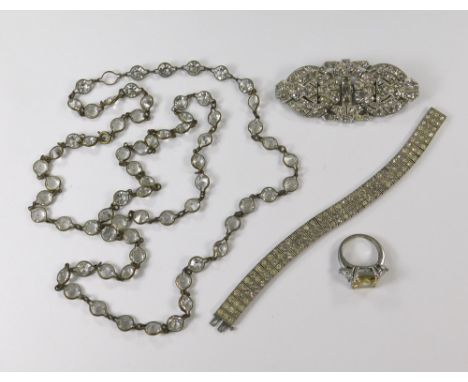 PASTE JEWELLERY. A large paste set double dress clip/brooch, width 7.5cm, a paste set bracelet, a long spectacle set necklace