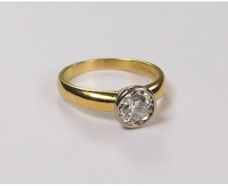 SOLITAIRE DIAMOND. A modern 18ct. gold solitaire diamond ring in a faceted collet setting. The diamond approx. 0.5CT. (NOT  1