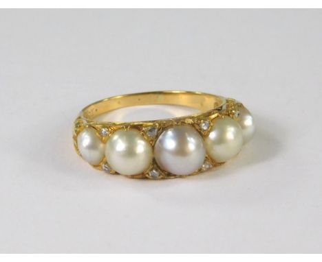 PEARL RING. An 18ct. gold dress ring, set a row of five large pearls interspersed with eight old cut diamond chips. Size R. A