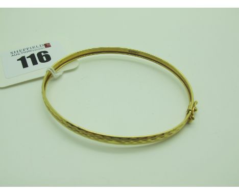 A Modern Dainty Bangle, of textured finish, stamped "375" (2.8grams). 