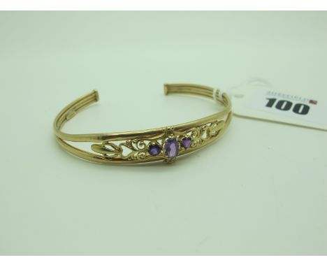 A Decorative Openwork Bangle, oval claw set. 