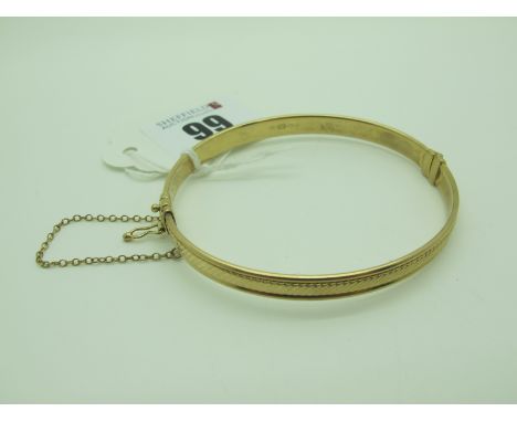A Modern Hinged Bangle, of texture finish, stamped "375" (9grams). 