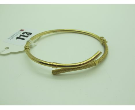 A 9ct Gold Hinged Bangle, of shaped design, semi textured (sprung hinge) (overall weight 4.4grams).  