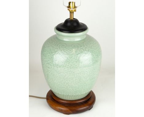 A MODERN OVOID CELADON GLAZED TABLE LAMP with turned wooden base and moulded decoration, 23cm diameter x 43cm high Condition: