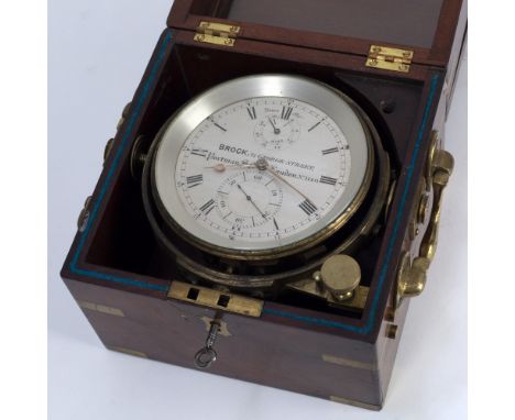 A MARINE CHRONOMETER by Brock, 21 George Street, Portman Square, London, set within a brass bound mahogany case with carrying