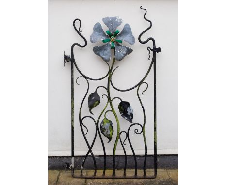 A PAINTED WROUGHT IRON GARDEN GATE of naturalistic form with central flower head, to fit in an entrance approximately 105cm w