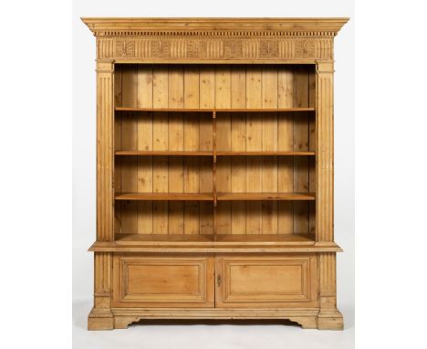 A PINE BOOKCASE with carved fluted cornice, fluted pilaster columns to either side and three open shelves, all over twin pane
