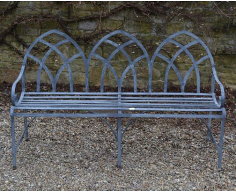 AN IRON REGENCY STYLE GARDEN BENCH  with arched back, 161cm wide x 94cm high Condition: weathered