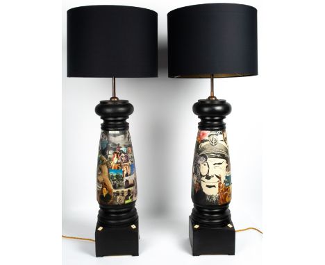 A PAIR OF BLACK PAINTED LARGE TURNED WOODEN TABLE LAMPS with collage decoration, 87cm high overall to the fitting together wi