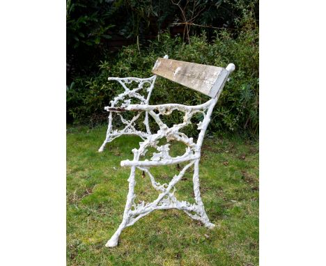 A VICTORIAN GARDEN BENCH with white painted cast iron ends, in the form of branches with entwined ivy decoration, 143cm wide 