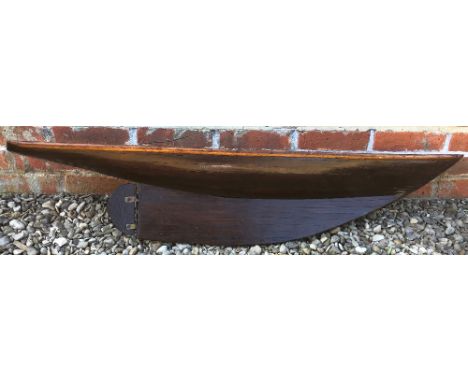 A VARNISHED WOODEN MODEL YACHT HULL 123cm long x 25cm wide x 25cm deep Condition: reasonable condition with signs of some sli