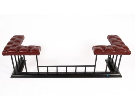 A CONTEMPORARY RED LEATHER BUTTON UPHOLSTERED CLUB FENDER on a black painted wrought iron base, 170cm wide x 59cm deep x 47.5