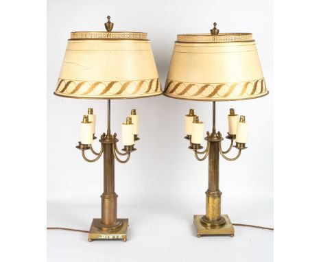 A PAIR OF CONTINENTAL BRASS TABLE LAMPS each with four scrolling branches, reeded support and square base on ball feet, each 