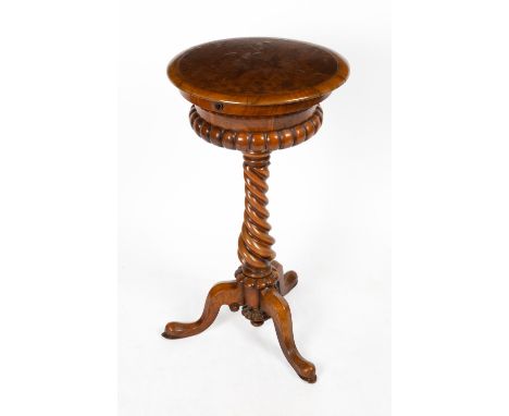A VICTORIAN WALNUT TEAPOY the circular lifting lid opening to reveal two lidded canisters and two cut glass bowls within, all