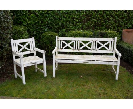 A WHITE PAINTED WOODEN GARDEN BENCH with X splats to the back, 150cm wide x 91.5cm high together with a matching armchair Con