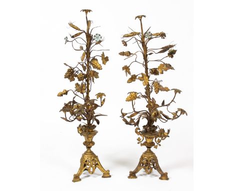 A PAIR OF GILDED TOLEWARE CANDELABRA of wheatsheaf and vine leaf form on a tripod base, each 95cm in height Condition: surfac