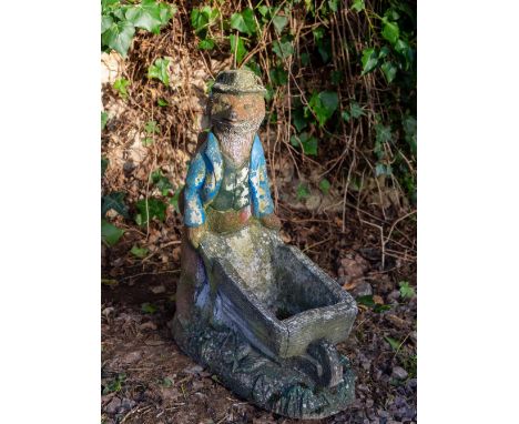A COMPOSITE STONE MODEL OF A FOXwith a wheelbarrow planter, 46cm wide x 55cm highCondition: surface wear and paint loss