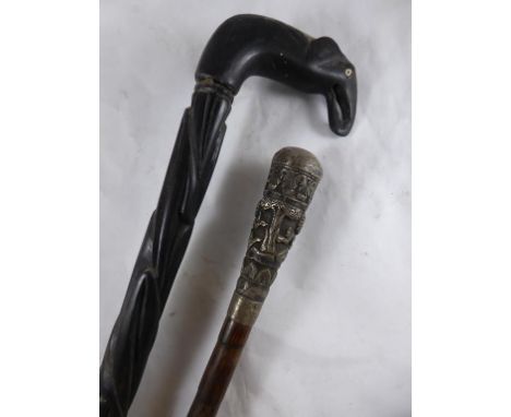 ELEPHANT HEAD HANDLE EBONY STICK AND A PARASOL HANDLE WITH REPOUSSE DECORATED INDIAN SILVER HANDLE